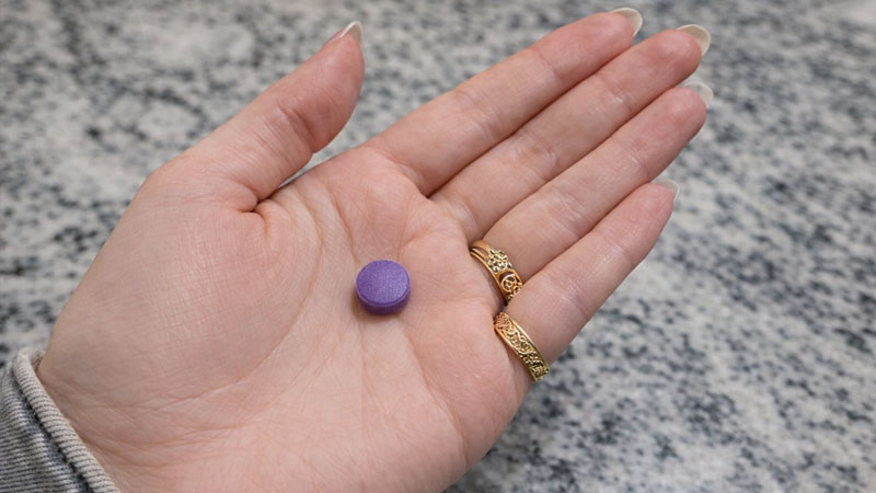 Purple tablet in hand